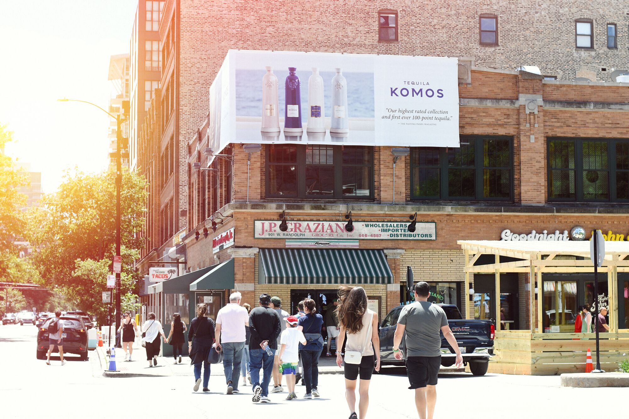 Komos billboard above a city street