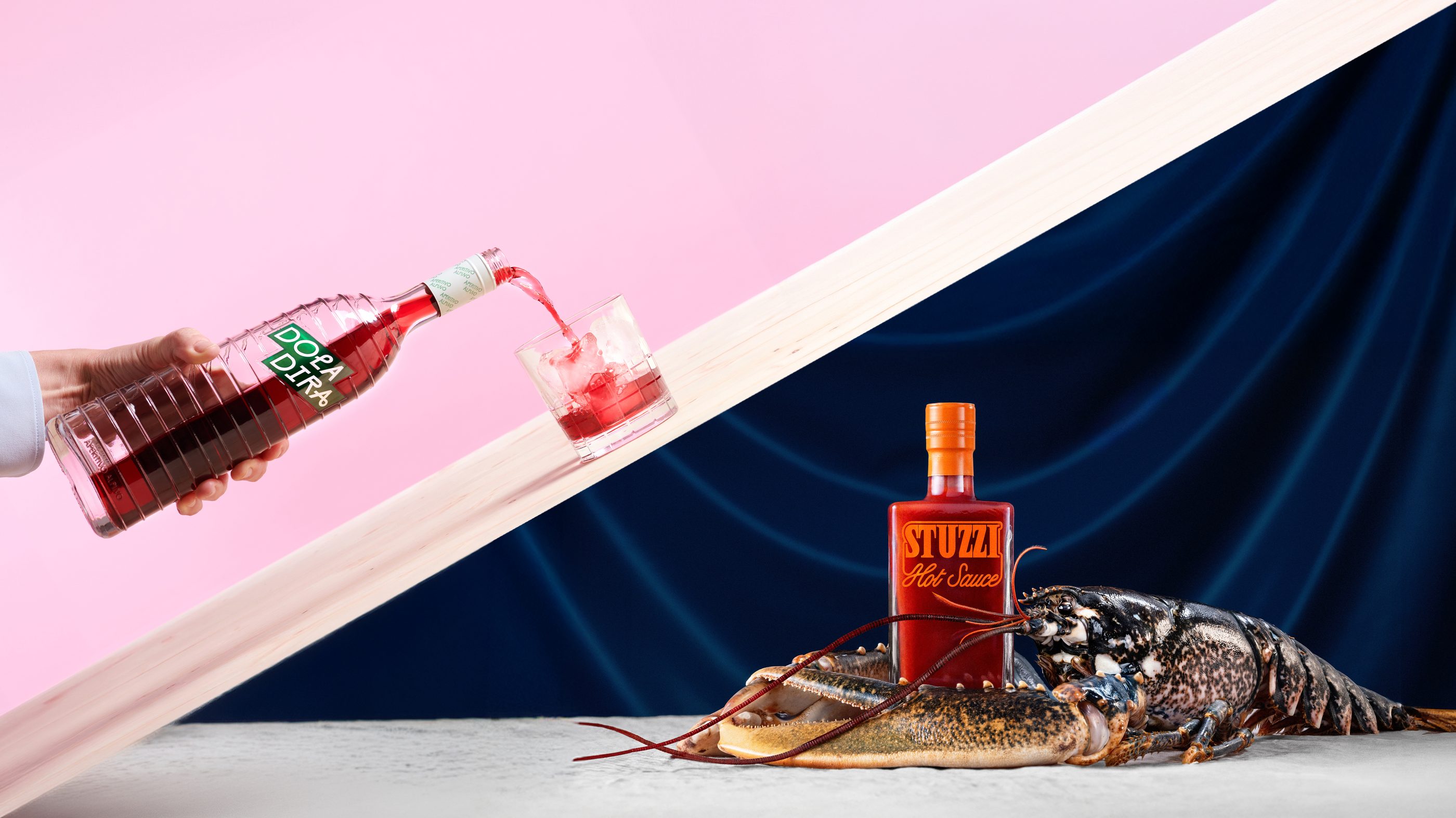 Doladira pouring and Stuzzi hot sauce with a lobster
