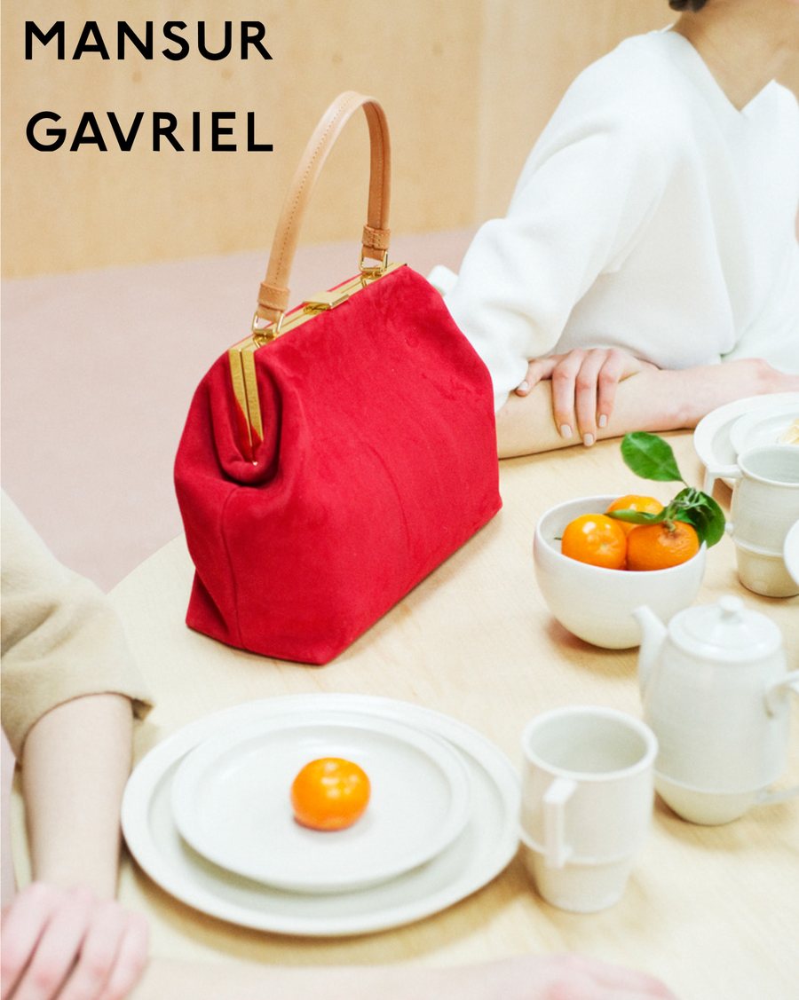 Mansur Gavriel red suede bag on a breakfast table